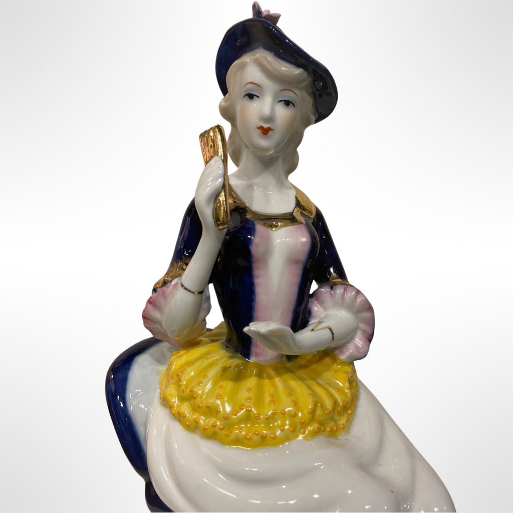 Figurine of Alice on a Blue Chair
