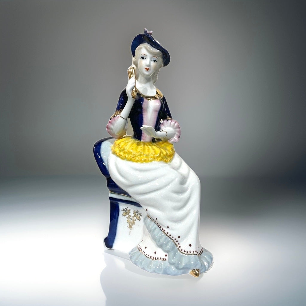 Figurine of Alice on a Blue Chair