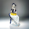 Figurine of Alice on a Blue Chair