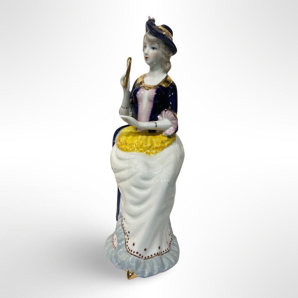 Figurine of Alice on a Blue Chair