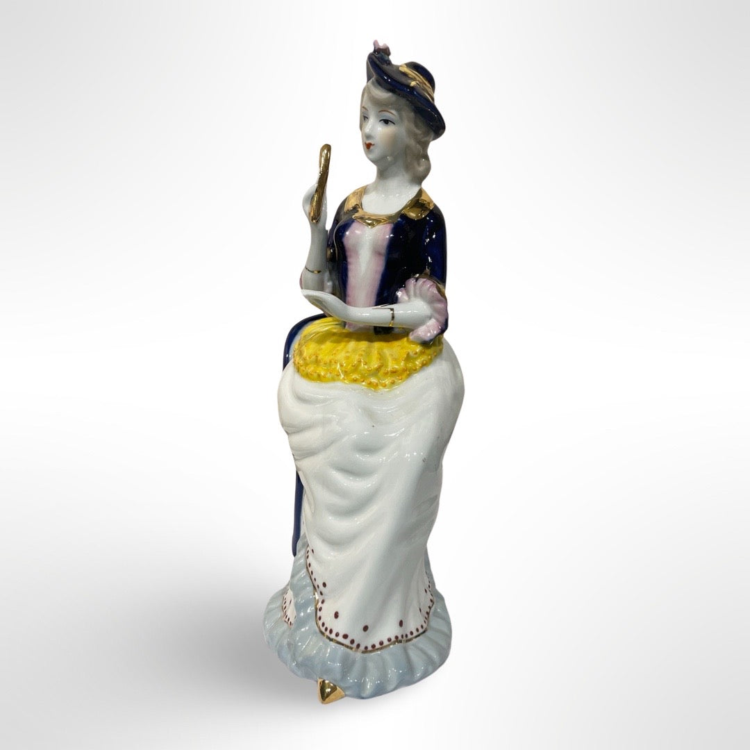 Figurine of Alice on a Blue Chair