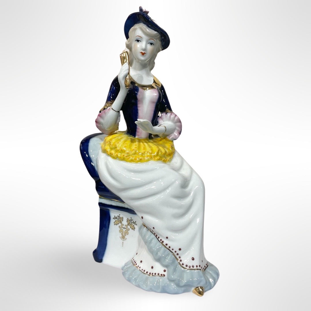 Figurine of Alice on a Blue Chair