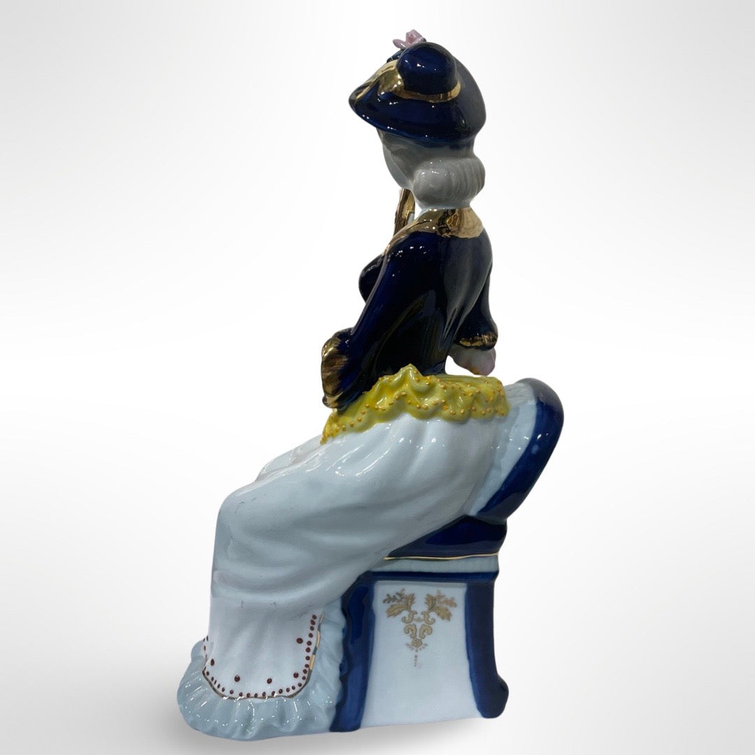 Figurine of Alice on a Blue Chair